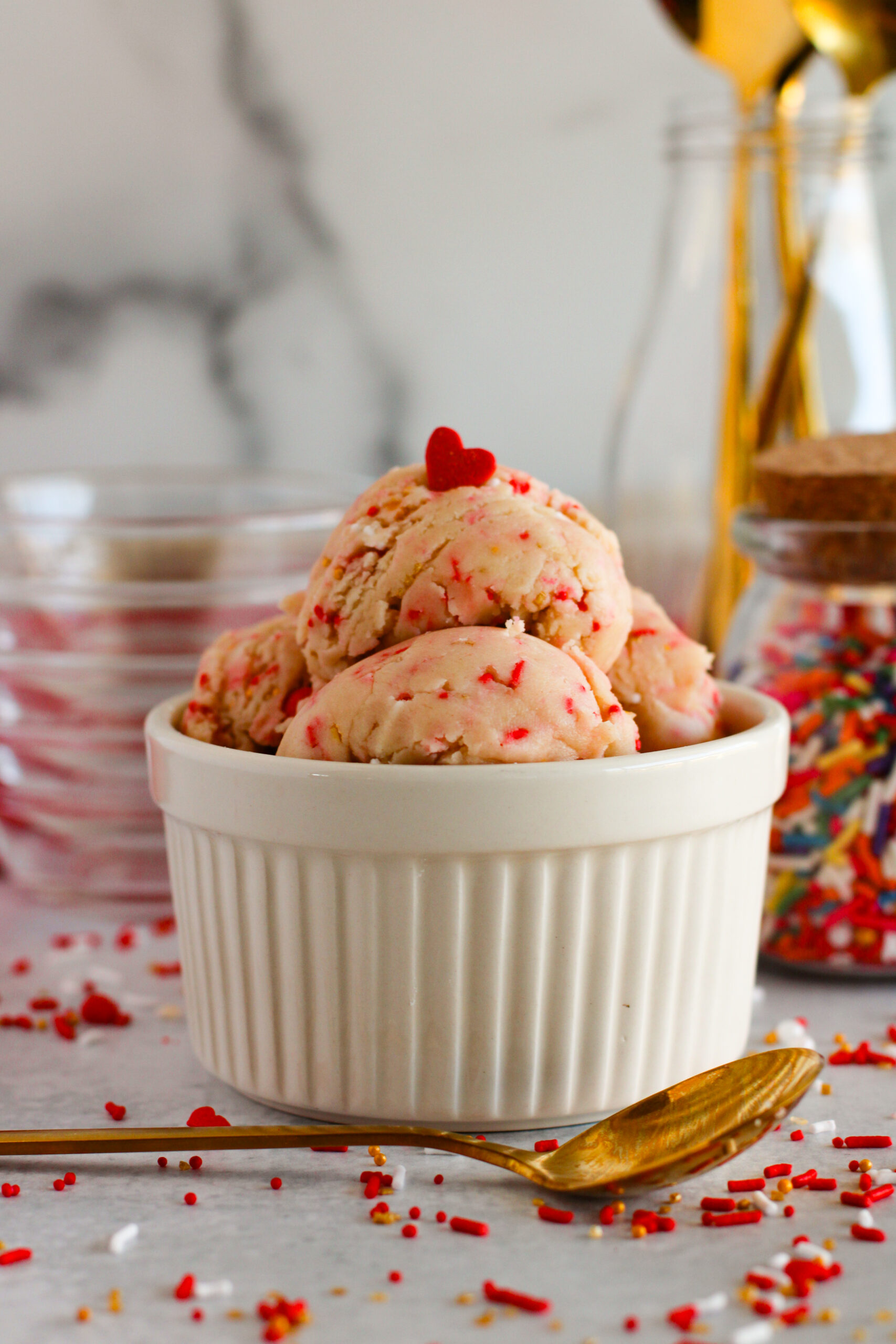 white bowl of edible sugar cookie dough with Valentine's sprinkles