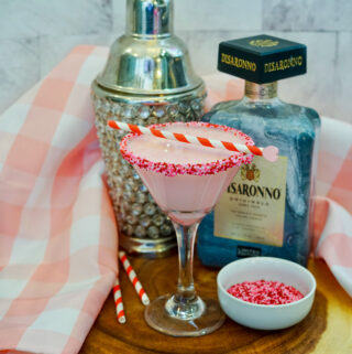 amaretto pink martini with pink napkin and ingredients at back
