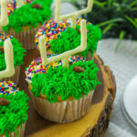 football cupcakes on wooden serving platter