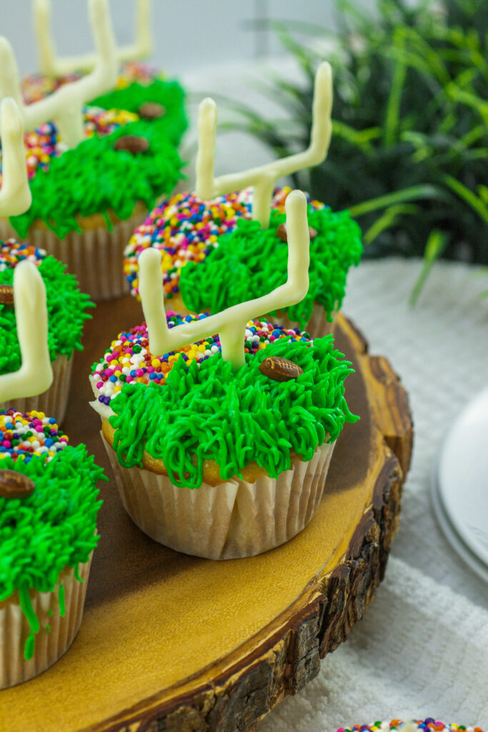 game day cupcakes shaped like a football field on wooden serving board