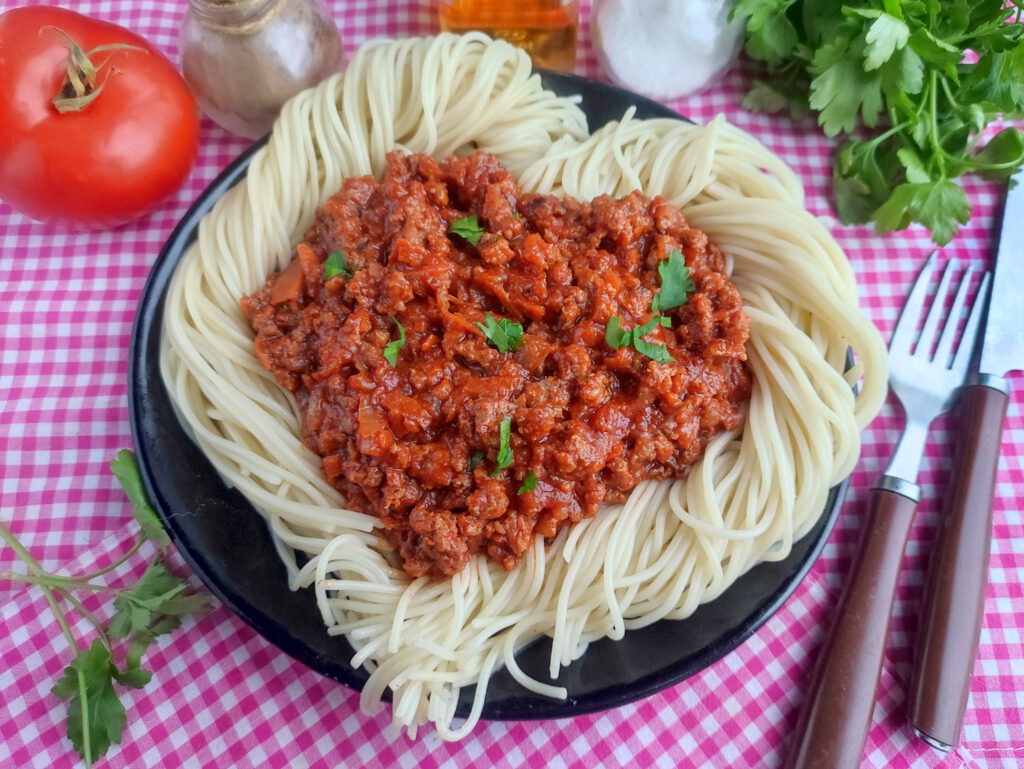 date night spaghetti in heart shape on pink plaid cloth