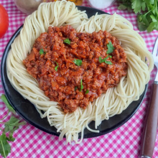 date night spaghetti shaped like a heart on black plate