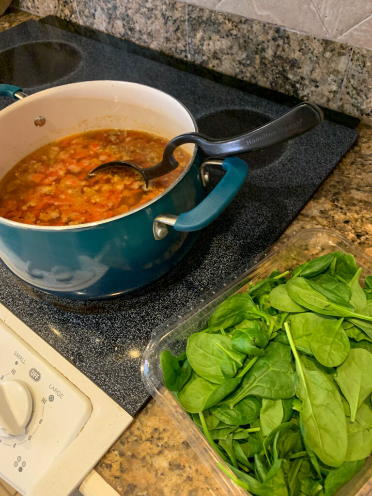 pot with pile of spinach to right