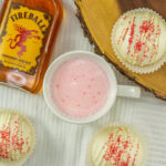 overhead view of white chocolate Fireball bombs with mug of Fireball cocoa