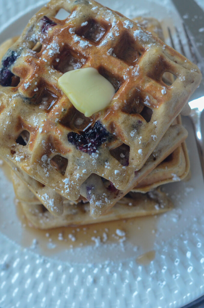 buttered blueberry waffles with powdered sugar