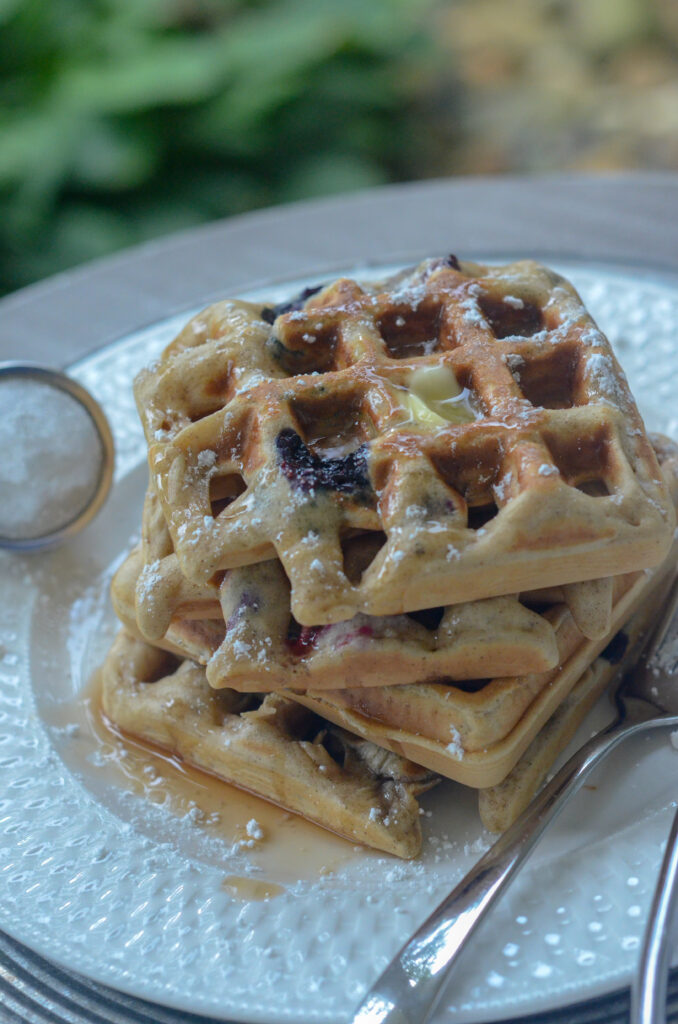 blueberry waffles stacked on white plate