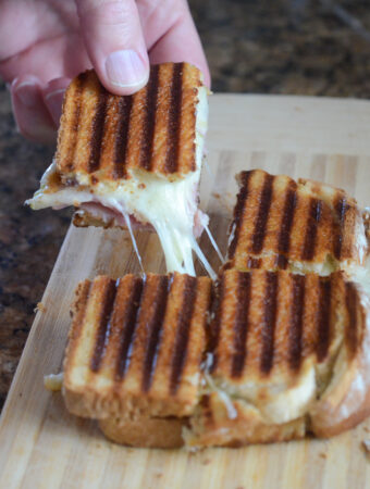 cheese and ham panini sandwich square pulled by man