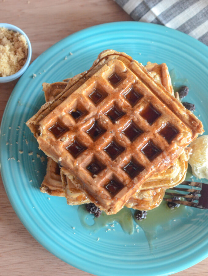 oatmeal raisin waffles on serving plate with striped napkin