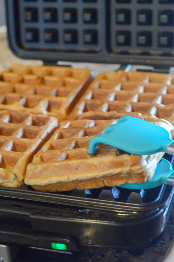 waffles being lifted from waffle maker
