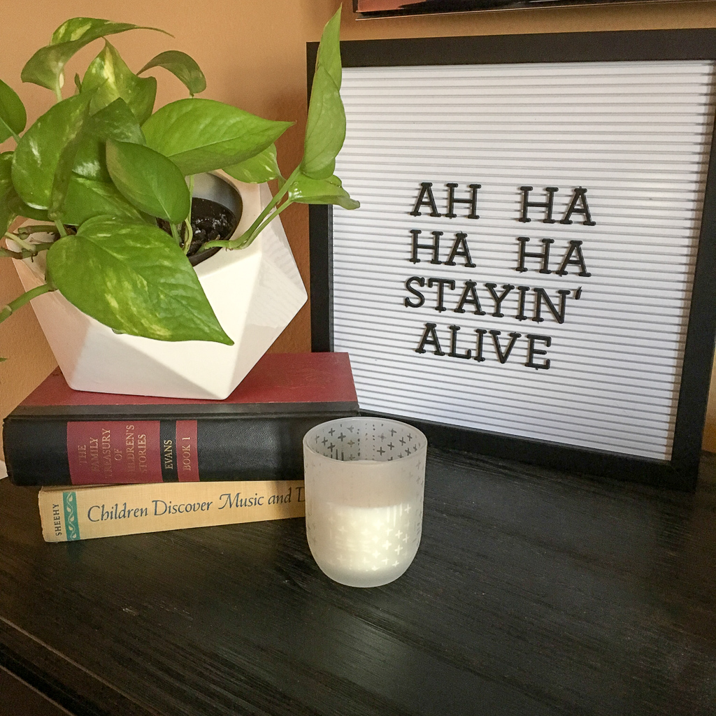 funny plant quotes on letter board next to stack of books with plant