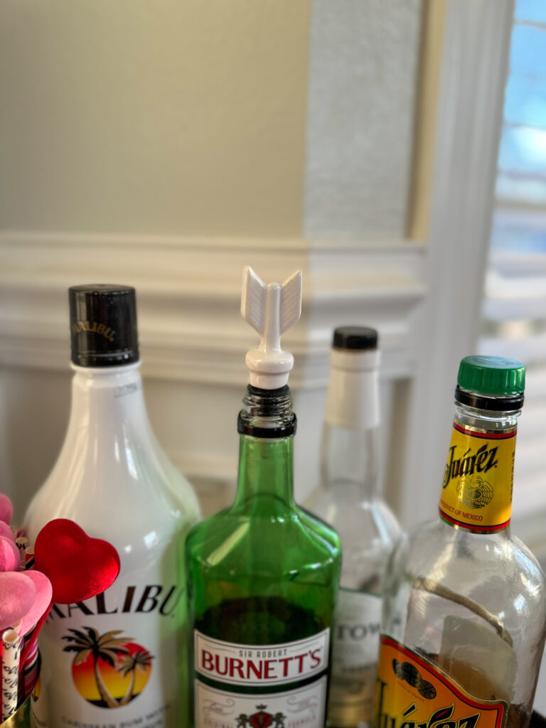 Valentine bar cart liquor bottles with arrow bottle stopper