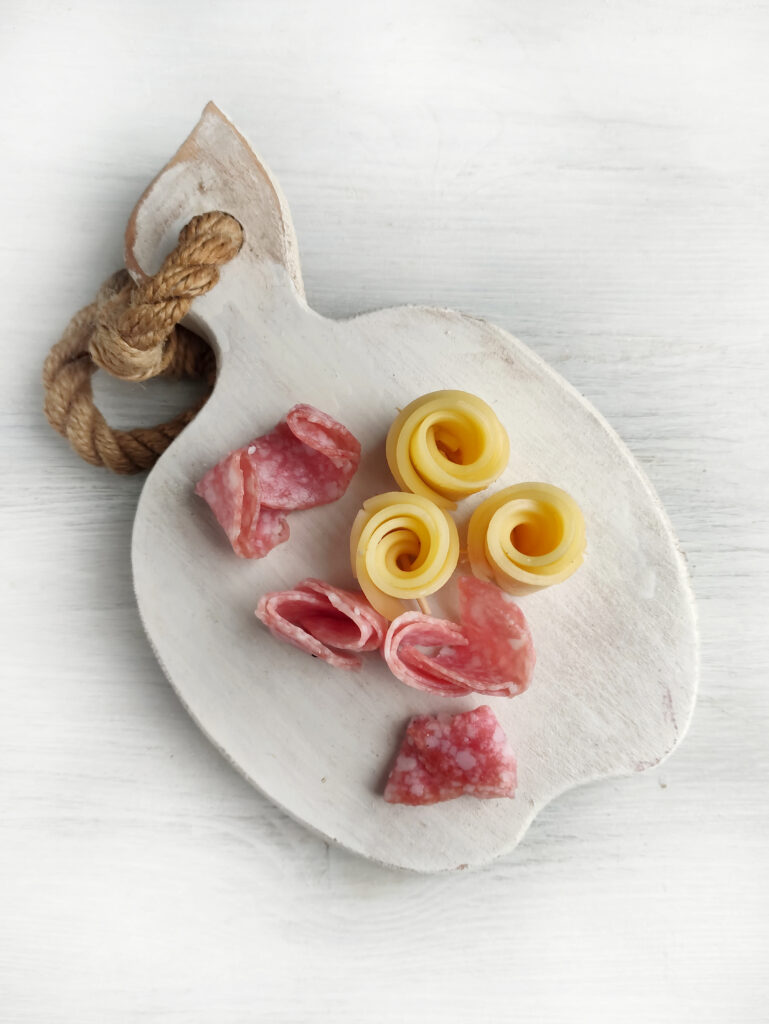 flower cheese slices and flower salami slices in preparation