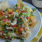 3 ingredient slow cooker shredded salsa verde chicken with ranch on nacho salad