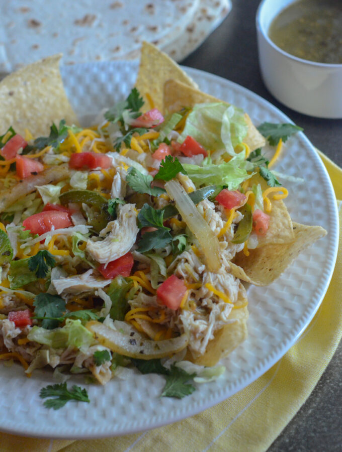 3 ingredient slow cooker shredded salsa verde chicken with ranch on nacho salad
