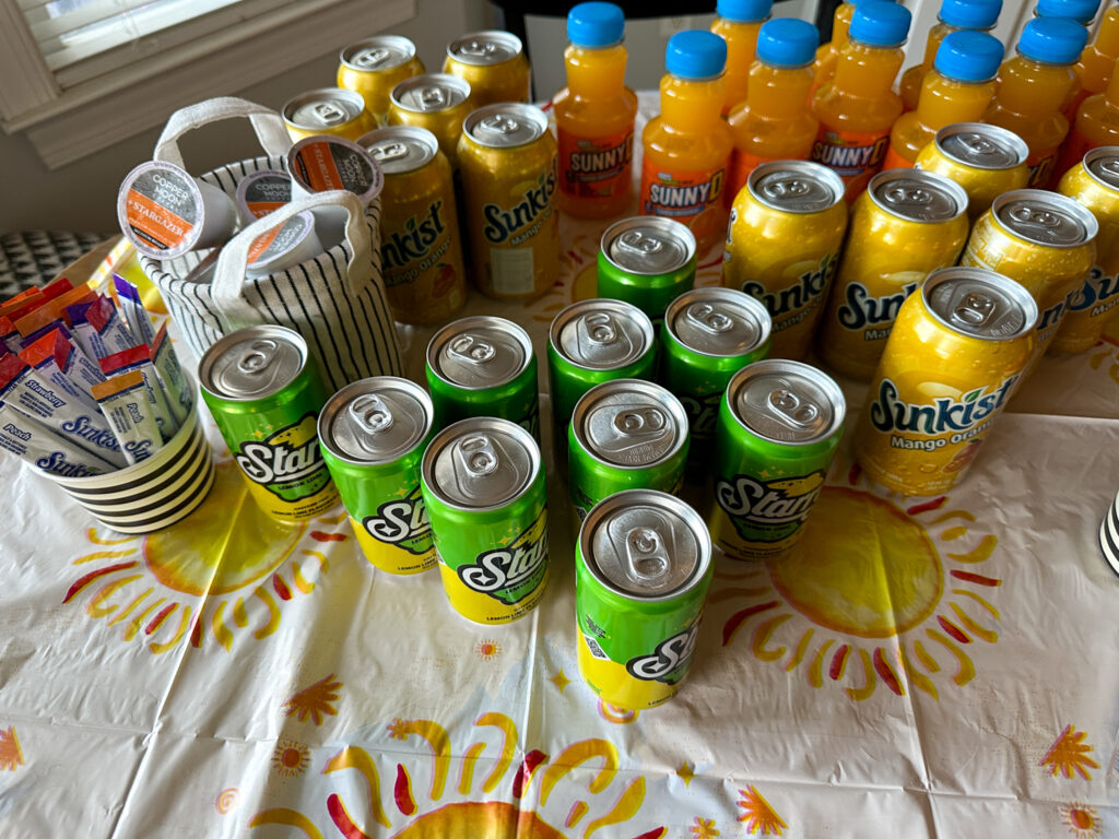 solar eclipse drinks on a sun tablecloth - Sunkist, Starry, Sunny D, and Copper Moon coffee pods