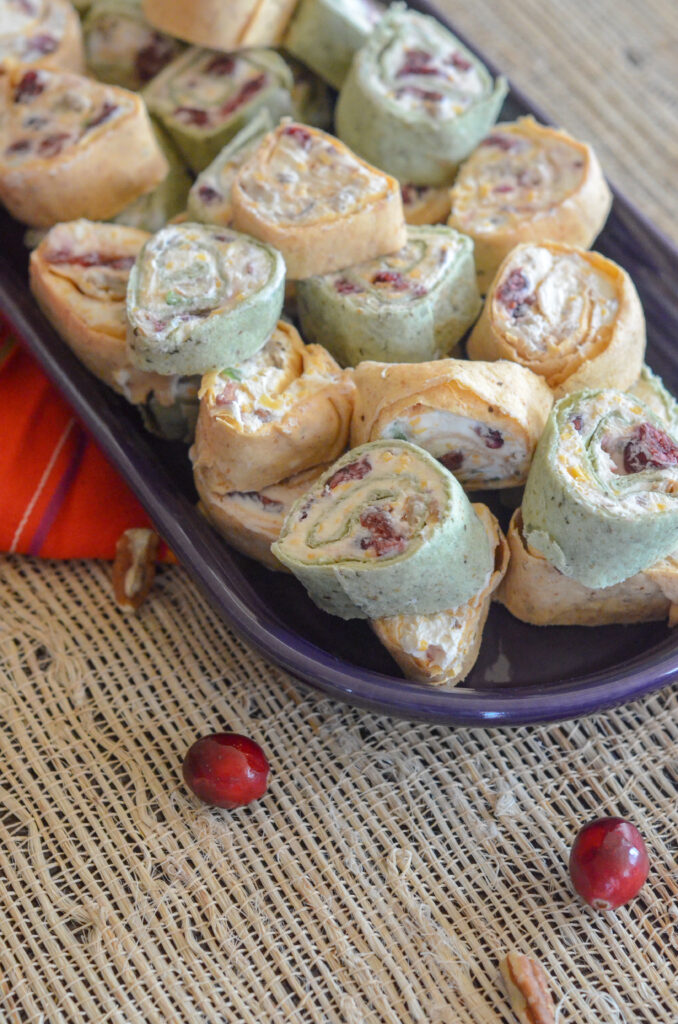 cranberry bacon tortilla roll ups on purple tray