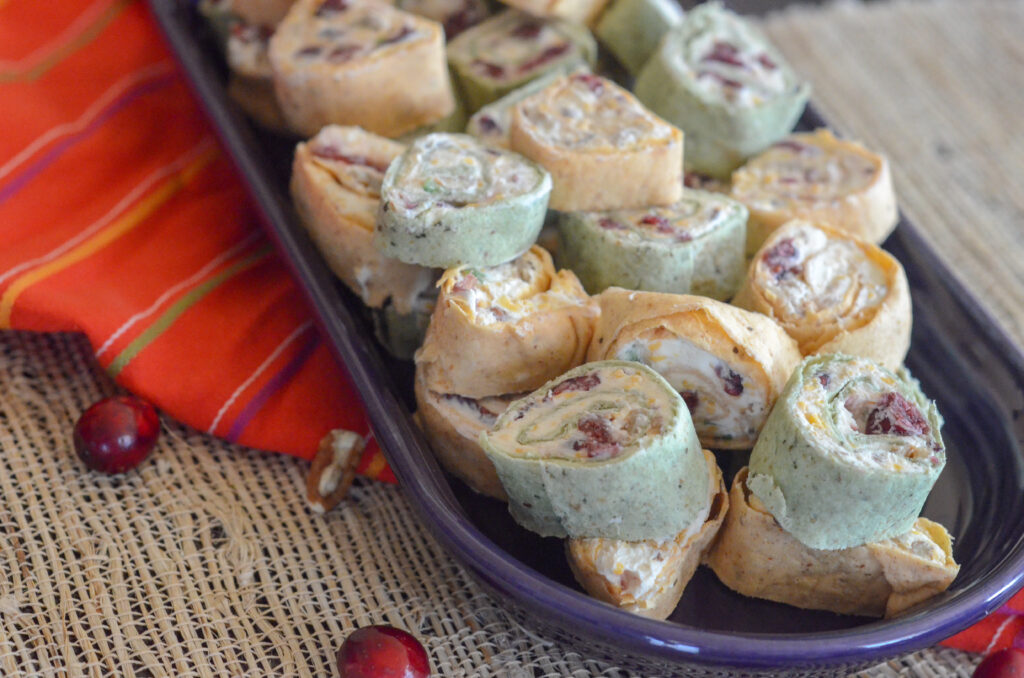 purple serving plate of cranberry tortilla roll ups with bacon