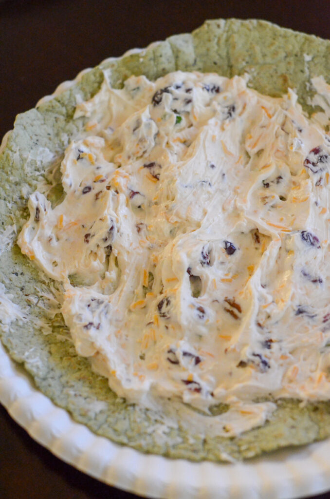cream cheese and cranberry ranch mixture spread on top of tortillas