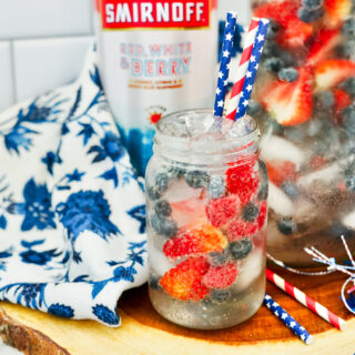 front shot of Smirnoff fruit punch with blue and white napkin at left
