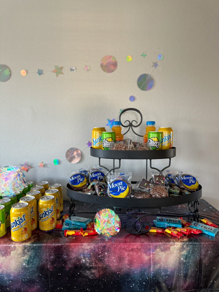 galaxy party table - outer space party ideas on table with Moon Pies, Orbit gum and Sunkist sodas