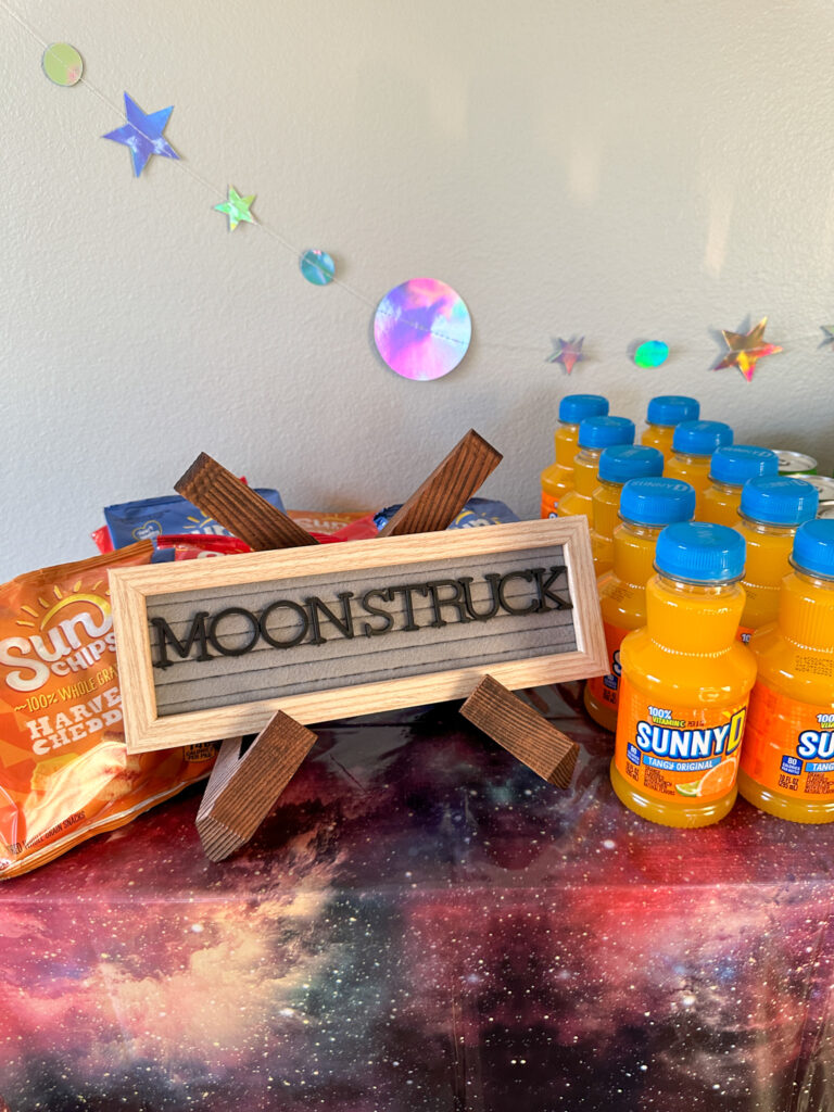 moonstruck letter board on a galaxy party table for outer space party ideas