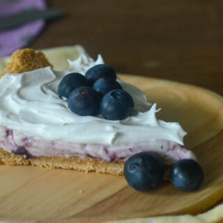 cold blueberry cream pie slice on brown plate