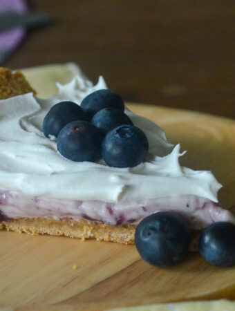 cold blueberry cream pie slice on brown plate