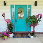 flamingo porch decor surrounding teal front door