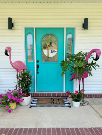 flamingo porch decor surrounding teal front door