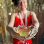 woman holds 1920s cocktail in hands