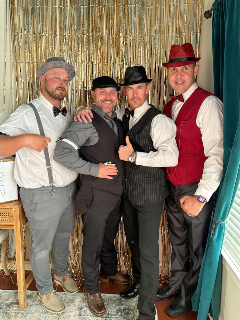 group of men dressed up in 1920s outfits for roaring 20s murder mystery party