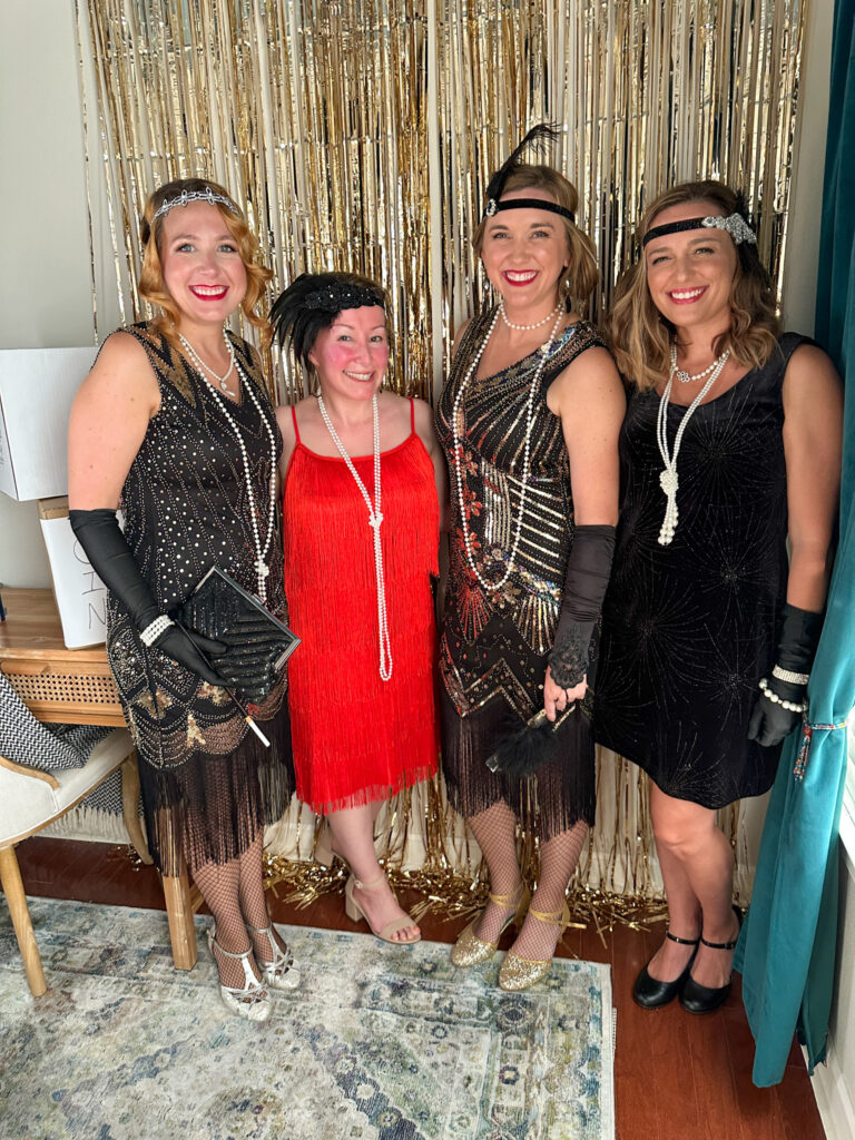 group of women in 1920s outfits at a 1920s party murder mystery style