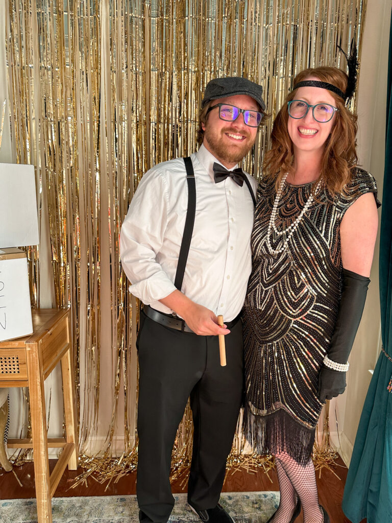couple dressed in 1920s outfits for Gatsby murder mystery party