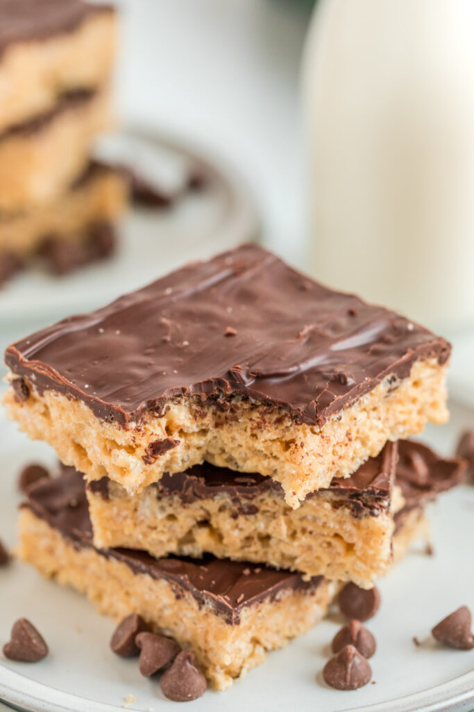 chocolate peanut butter Rice Krispie treats stacked on white plate