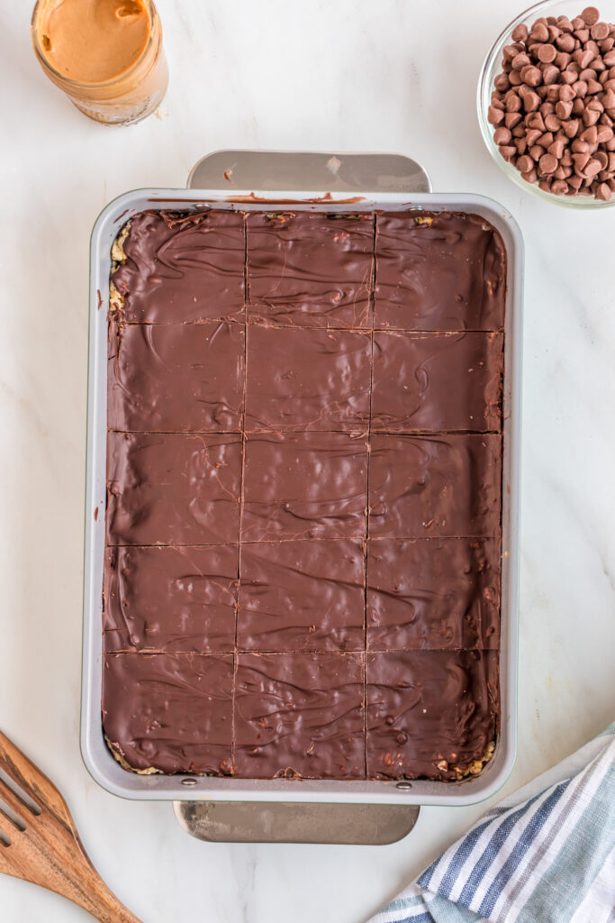 chocolate peanut butter Rice Krispie treats in a pan with cut marks