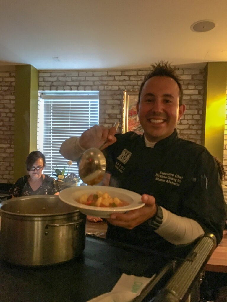 Chef at Savannah cooking class plating a dish