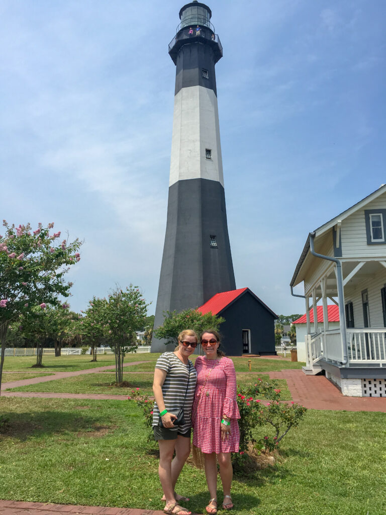 two women standing in front of Tybee Lighthouse