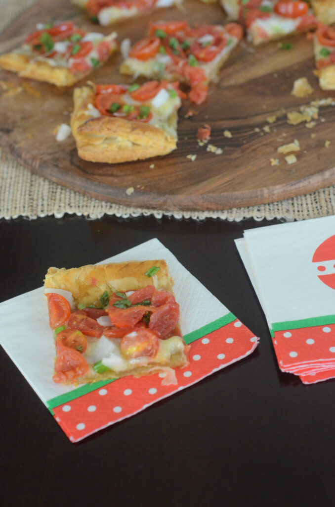 cherry tomato tart on puff pastry as a holiday appetizer in Christmas colors