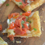 tomato tart with puff pastry sliced on napkins