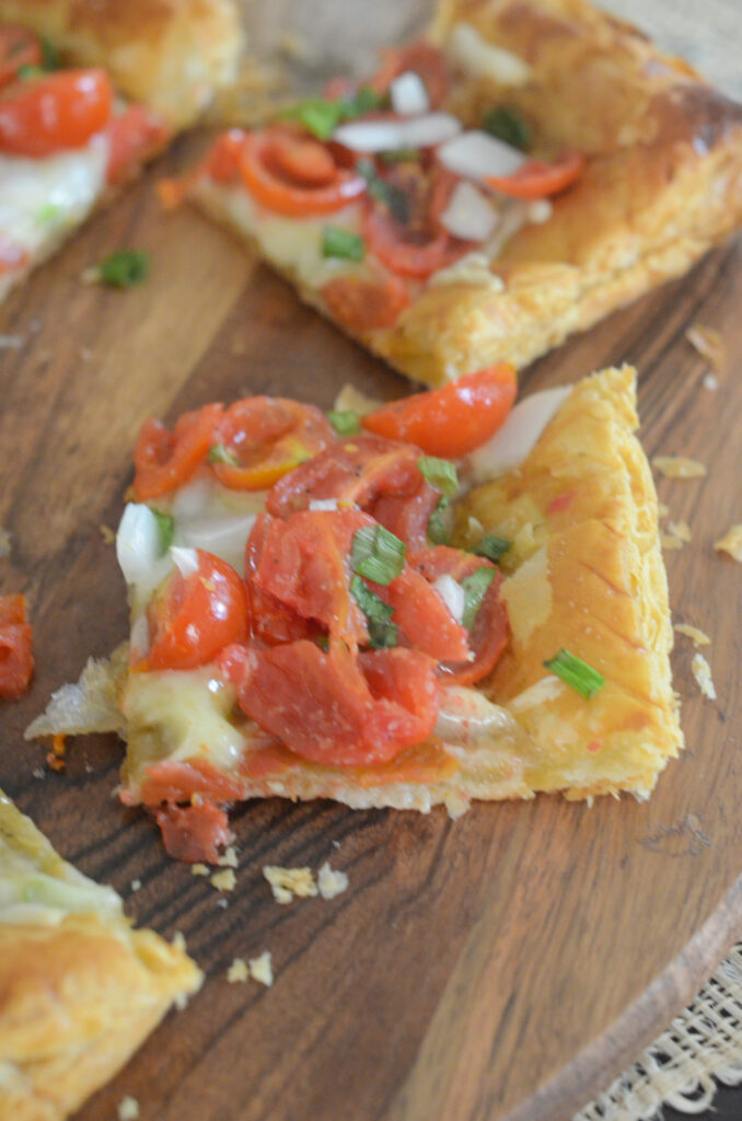 slices of tomato tart with puff pastry on serving tray for a holiday appetizer idea