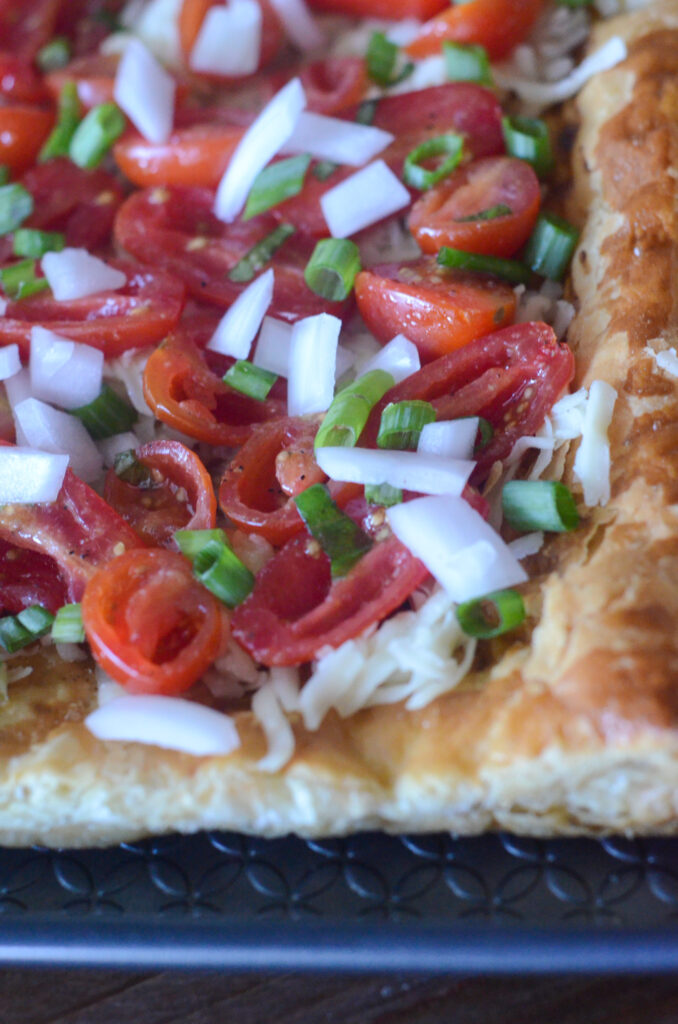 Christmas cherry tomato tart with puff pastry crust in preparation