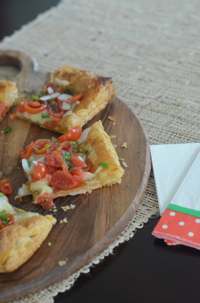 Christmas tomato tart with puff pastry on wood board