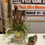 Wild Game Dinner table decor with sign in background