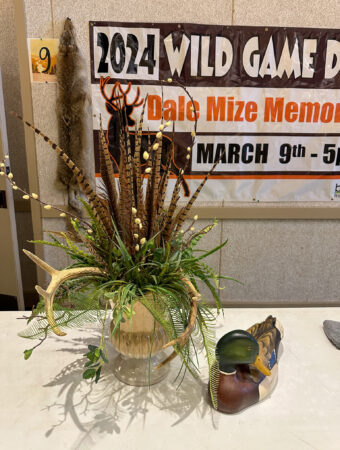 Wild Game Dinner table decor with sign in background