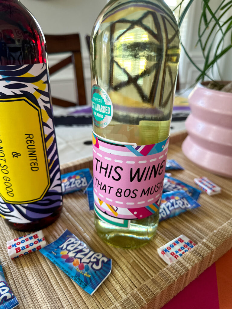 free printable 80s wine bottle labels for 1980s theme party - on tray with Razzlers and Bazooka candy