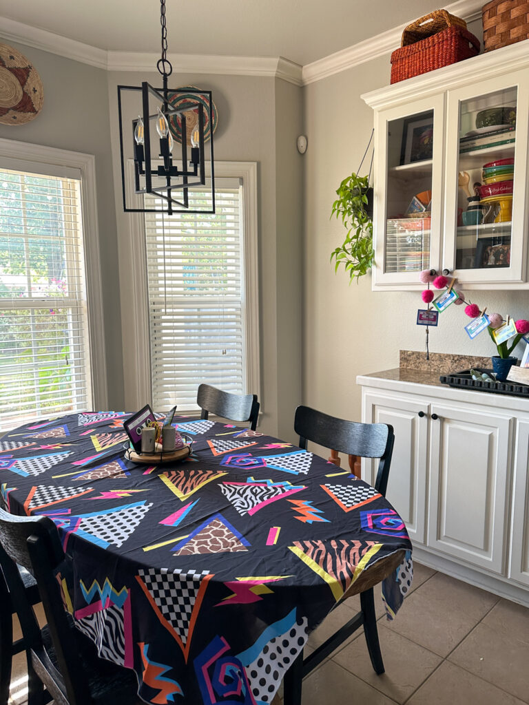 Memphis fashion style 1980s tablecloth on table as 1980s theme party decorations