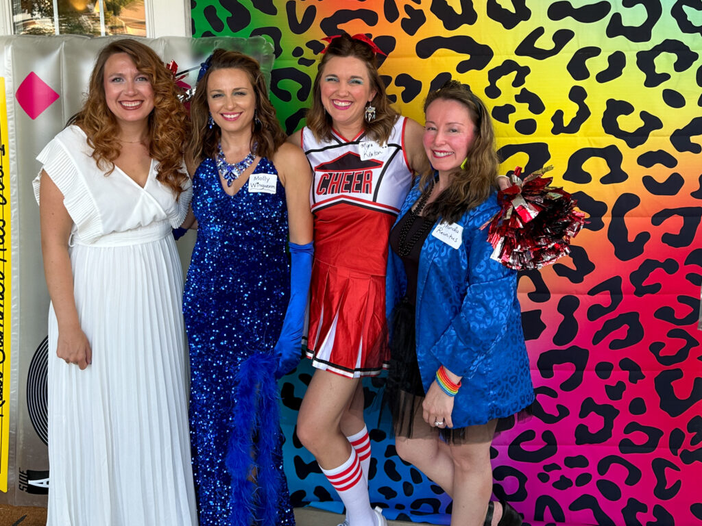 women in 1980s costumes at 1980s theme party