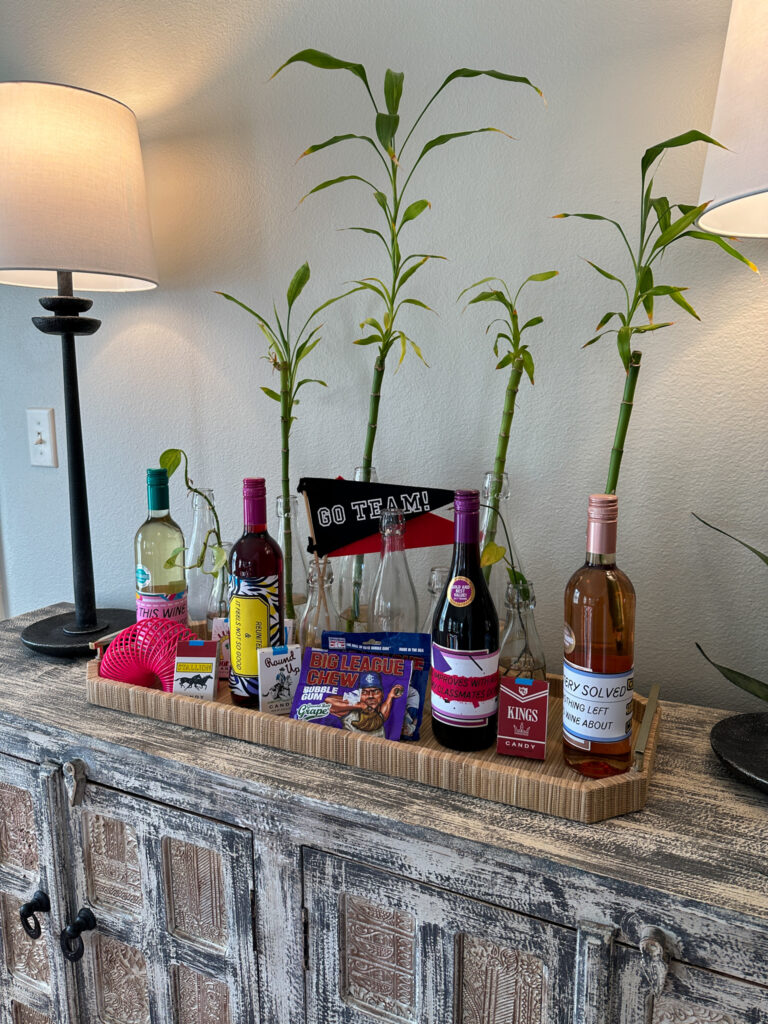 tray of 1980s candy and Big League Gum with wine bottles covered with DIY printable 1980s wine bottle labels