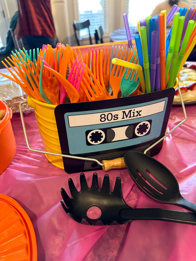 utensil holder with 1980s party ware and cassette tape cutout on front