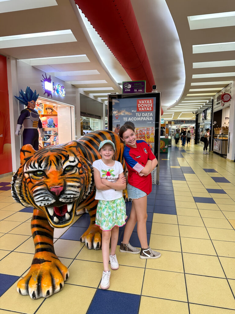 girls stand at Tiger entrance in Albrook Mall in Panama City, Panama